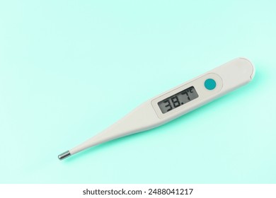 A digital thermometer with the temperature of 38.2 degrees on the screen. The thermometer is white and has a blue button on the side