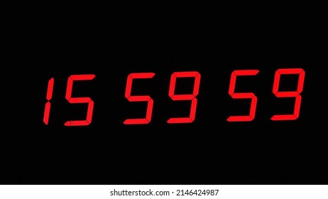 Digital timer on a black background. Light panel with red numbers