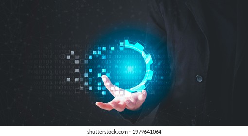 Digital transformation concept. Hand holding modern interface futuristic blue gear digital and binary coded background. Connection next generation technology and new era of innovation. 