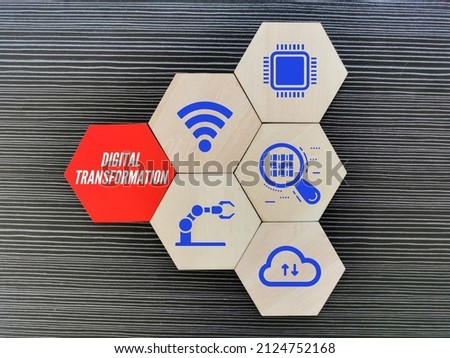 Digital transformation concept with icons on wooden hexagon.