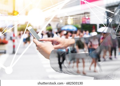 Digital Transformation Of Internet Of Things Technology Disruption , Big Data ,online Shopping Concept. Neural Networks Connect Atoms , Business Man Using Smart Phone And Blur City People Cross Road.