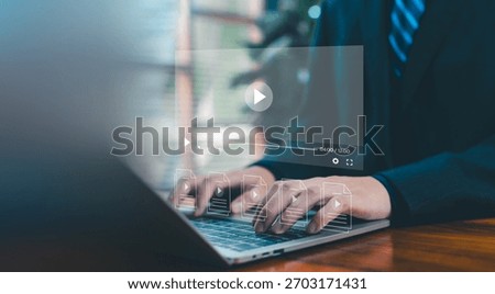 A digital video interface floating above a laptop as hands type, representing online media creation, streaming technology, content management, and modern workflow for professional video production.