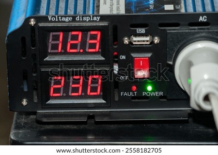 Digital voltage display unit showcases two readings for AC and DC currents. The interface features lights indicating power status and fault conditions.