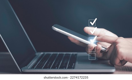 Digital work checklist or electronic smart daily checklist concept. Check mark on virtual screen display for personal working in office Document Management System and process automation. - Powered by Shutterstock