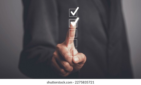 Digital work checklist or electronic smart daily checklist concept. Check mark on virtual screen display for personal working in office Document Management System and process automation. - Powered by Shutterstock