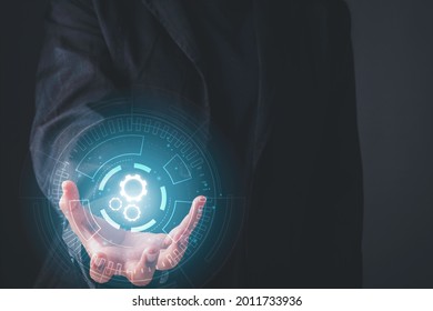 Digital workflow, Digital transformation, Automatic technology concept. Businessman holding digital machine gears  icons in cyber circle.