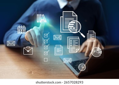 Digital workspace with a man interacting with virtual icons on a laptop during a productive session