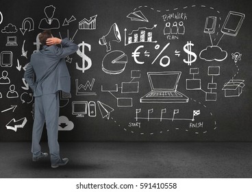 Digitally generated image of confused business professional looking at the blackboard