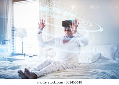 Digitally generated image of volume dial with digital interface against senior woman using virtual headset on bed 3d - Powered by Shutterstock