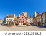 Dijon city historical centre with old typical houses colorful buildings and merry-go-round carousel on La Fontaine Place Francois Rude square, cityscape Dijon old town, Bourgogne region, France