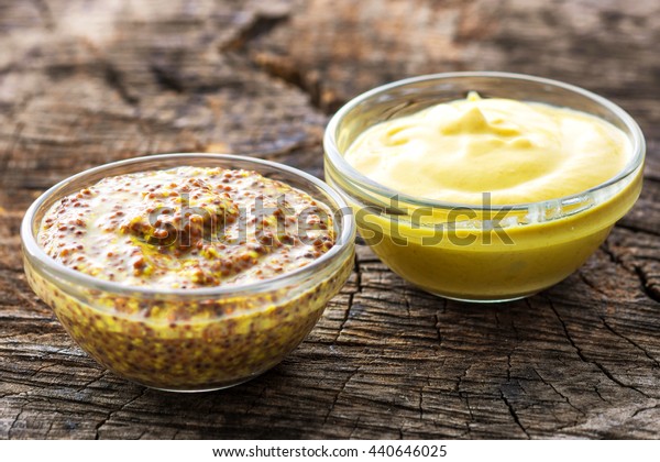 Dijon mustard\
and mustard on wooden\
background