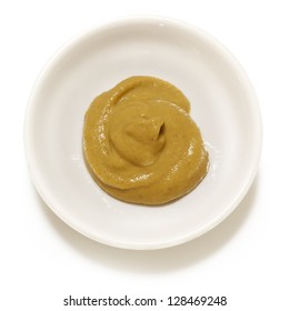 Dijon Mustard In Small White Bowl, Isolated.  Overhead View.