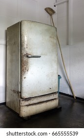 Dilapidated, dirty and rusty vintage refrigerator