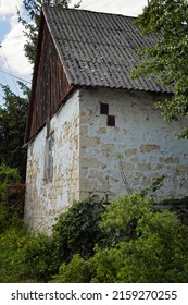 A Dilapidated Facade Of A Small Brick House. Poland