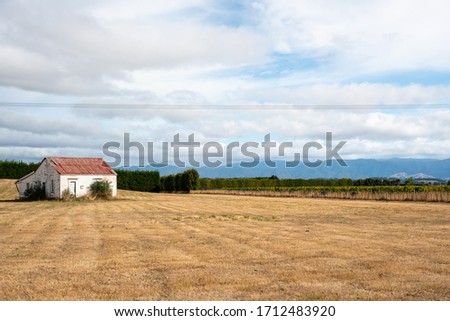 Dilapidated old wooden barn in the paddock on a rural farm in the country