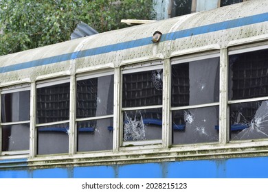 Dilapidated and rusty bus with broken windows in a remote area. Scrap.