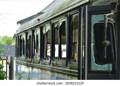 Dilapidated and rusty bus with broken windows in a remote area. Scrap.