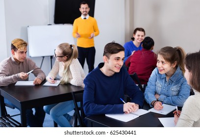 Diligent Glad  Positive Fellow Students Having Group Work Tasks During School Day