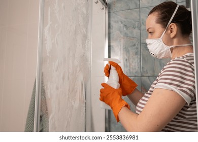 A diligent woman, in protective gear, deep cleans her shower, focusing on hygiene, freshness, and sanitation - Powered by Shutterstock