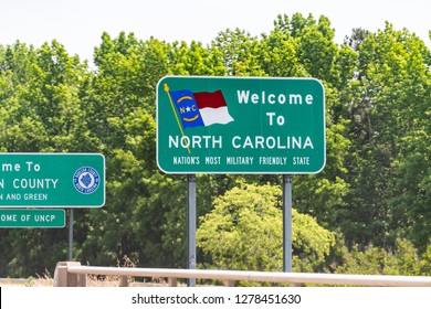 Dillon, USA - May 13, 2018: Highway road in North Carolina with closeup of welcome sign and text for nation's most military friendly state