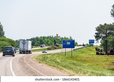 Dillon, USA - May 13, 2018: Highway road in SC South North Carolina border with cars, trucks in traffic and Mexican Hat Landmark