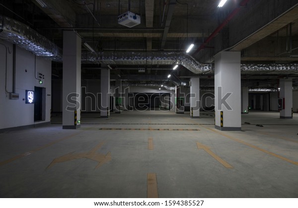 Dim large underground\
parking space