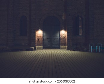 Dim lights in front of big metal doors at night. Location: Turku, Finland. - Powered by Shutterstock