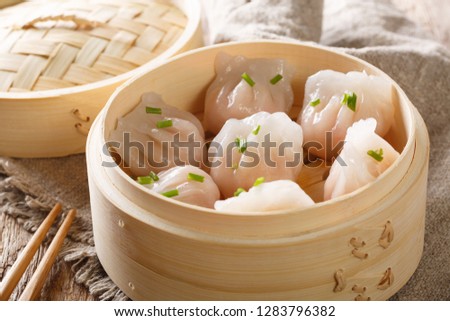 Dim Sum in bamboo steamer, Chinese cuisine. Closeup rustic style. horizontal
