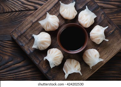 Dim Sum Dumplings On A Rustic Wooden Serving Board, Top View