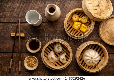 Dim sum, Dim Sum on the wooden table, top view and space for text input , Dim Sum (Chinese food) in steamed bamboo