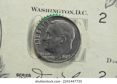 the dime coin, American money coin of 10 ten cents 1977 features the profile of Franklin D. Roosevelt the 32nd president of the United States of America, old USA vintage retro coin on USD banknote