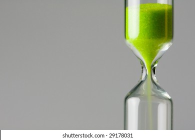 Diminishing Green. Ecology / Environment Concept Image. Green Sand Of Hour Glass Falling Down.