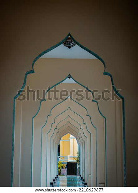 Diminishing perspective\
interior view of inner Bang O mosque hallway leading into outside\
building. Scenic idyllic, Mosque architecture and art concept,\
Selective focus.