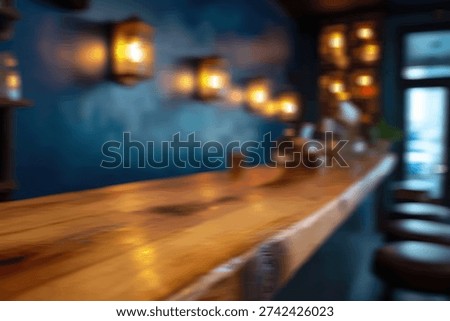 A dimly lit bar interior featuring a rustic wooden countertop and warm, inviting pendant lights on a textured blue wall.