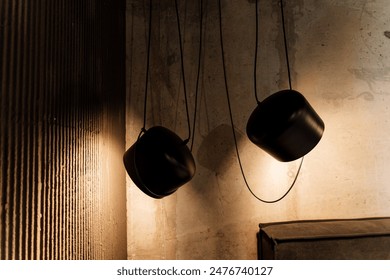 The dimly lit industrial room with hanging lamps creates a moody ambiance through shadow play on textured walls, inspiring design and lighting decor themes for a chic and stylish home - Powered by Shutterstock