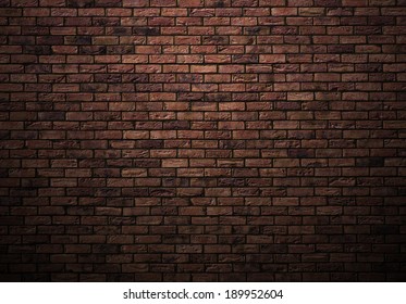 dimly lit old brick wall