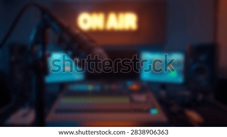 A dimly lit recording studio features a professional audio mixer, monitors, and a microphone under an illuminated ON AIR sign.