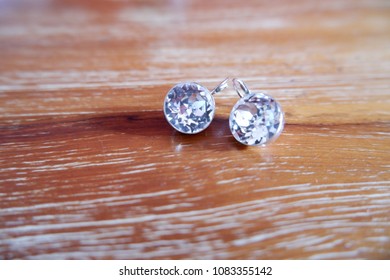 Dimond Earings On The Wooden Table