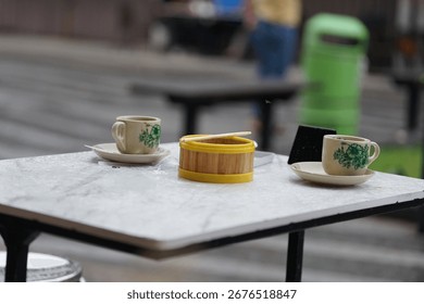 A dimsum place and two empty cups of coffee on the table in a cafe in the Citra Niaga area of ​​Samarinda.
