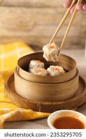 Dimsum is a unique food from Hong Kong which contains shrimp, fish or meat. which is served on a special bowl of dim sum with a small bowl of spicy sauce