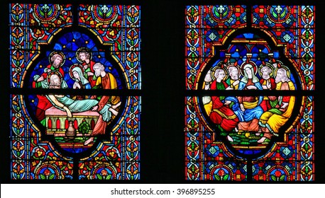 DINANT, BELGIUM - OCTOBER 16, 2011 Stained glass window depicting Jesus laid in His tomb and Mother Mary and the Apostles at Pentecost, in the Notre Dame church in Dinant, Belgium