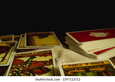 Dindeang ,Thailand - December 21,2019:  Tarot card deck and cards are placed on the table that the fortune teller performs. Horoscope and fate. Use Six Senses and spell Top is covered with white cloth
