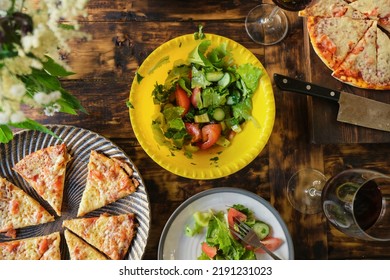 Dining Al Fresco. Dinner Table With Vegetable Salad And Pizza. Eating Outside. Summer Food On Wooden Table, Overhead View.