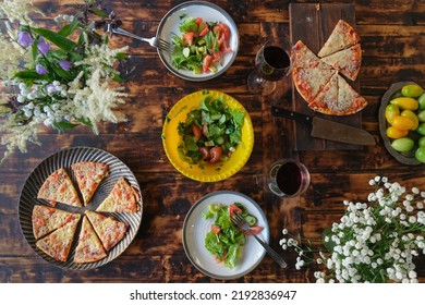 Dining Al Fresco. Dinner Table With Vegetable Salad And Pizza. Eating Outside. Summer Food On Wooden Table, Overhead View.