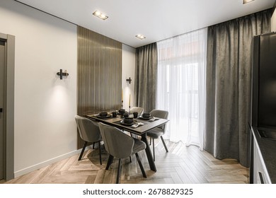 A dining area features a table set for four, with gold accents on the wall and curtains flanking a bright window