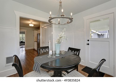 Dining black round table with four cushioned chairs in classic American Dining room. Northwest, USA