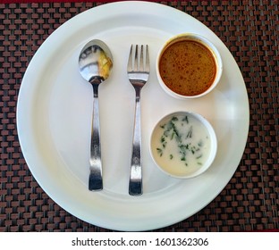 Dining plate with spoon and fork.