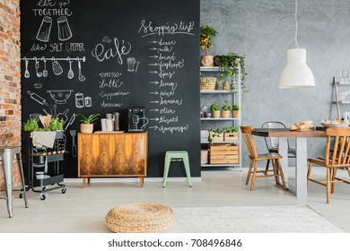 Dining Room With Chalkboard Wall, Wooden Chest And Kitchen Cart