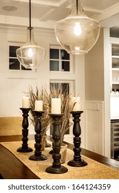 Dining Room Detail In Luxury Home: Dining Room Table, Pendant Lights, And Candles