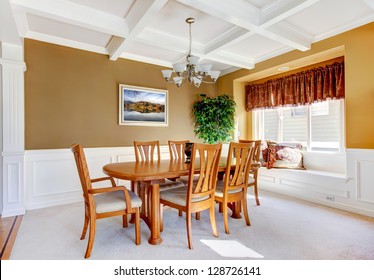 Dining room interior with white bench and wood table.